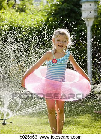 girl playing in a sprinkler View Large Photo Image Stock Image - girl playing in a sprinkler. Fotosearch