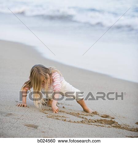 girl playing in the sand View Large Photo Image Stock Image - girl playing in the sand. Fotosearch