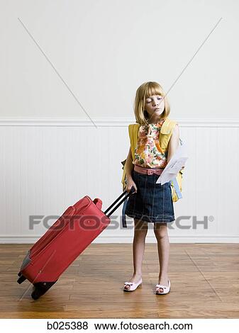 Stock Photo - girl pulling a suitcase. Fotosearch