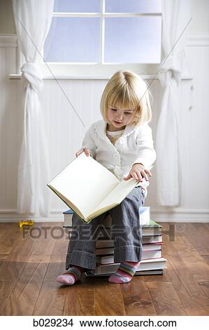 Picture - girl reading a book. Fotosearch