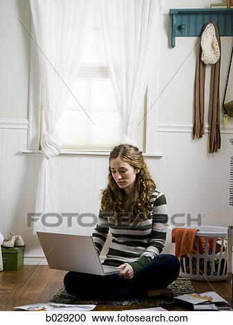 Stock Image - girl using a laptop. Fotosearch