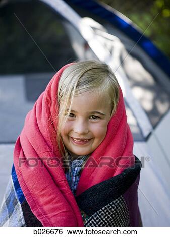 girl wrapped in a blanket in her backyard View Large Photo Image Stock Photograph - girl wrapped in a blanket in her backyard. Fotosearch