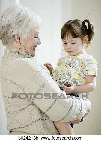 Stock Image - grandmother holding granddaughter. Fotosearch