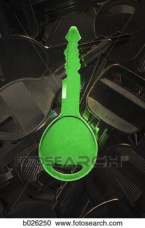 Stock Image - green key among other keys. Fotosearch