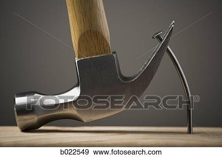 hammer pulling out a nail View Large Photo Image Stock Photo - hammer pulling out a nail. Fotosearch