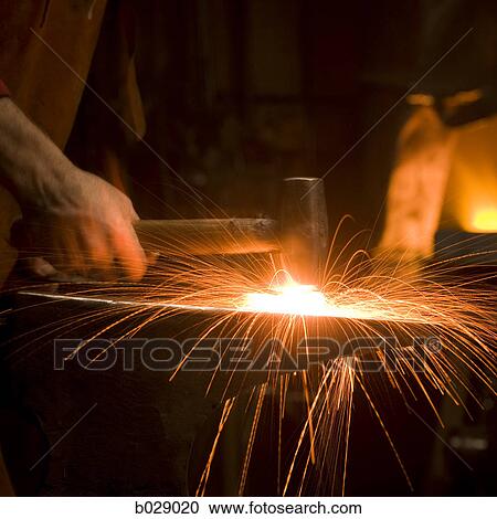 hammer striking a piece of hot metal on an anvil View Large Photo Image Stock Image - hammer striking a piece of hot metal on an anvil. Fotosearch
