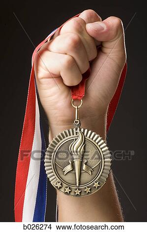hand holding a gold medal View Large Photo Image Picture - hand holding a gold medal. Fotosearch