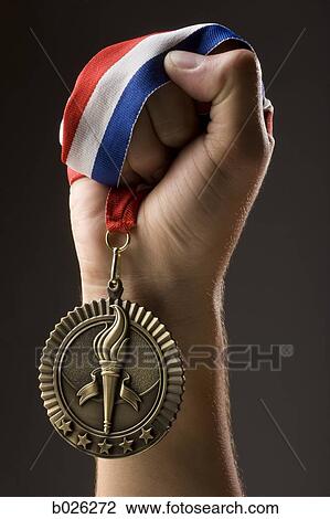 hand holding a gold medal View Large Photo Image Stock Image - hand holding a gold medal. Fotosearch