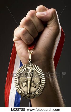 hand holding a gold medal View Large Photo Image Stock Photo - hand holding a gold medal. Fotosearch