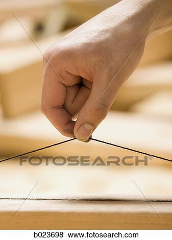 hand holding a plumb line View Large Photo Image Stock Photo - hand holding a plumb line. Fotosearch