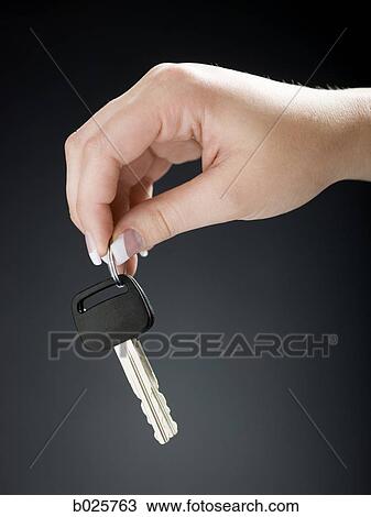 hand holding out a car key View Large Photo Image Stock Image - hand holding out a car key. Fotosearch