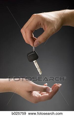hand holding out a car key View Large Photo Image Stock Photo - hand holding out a car key. Fotosearch