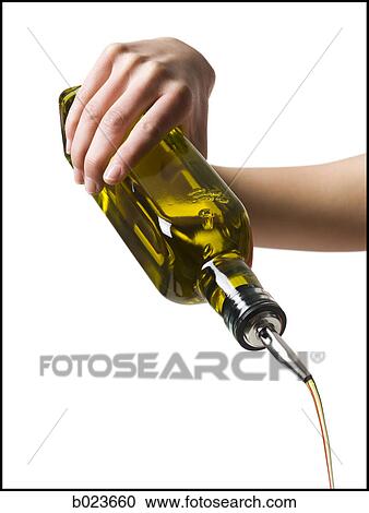 Stock Image - hand pouring olive oil. Fotosearch