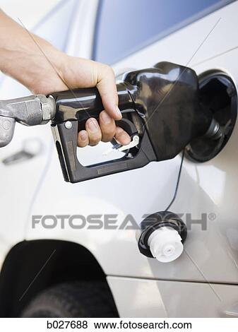 hand pumping gas into a car View Large Photo Image Stock Photo - hand pumping gas into a car. Fotosearch