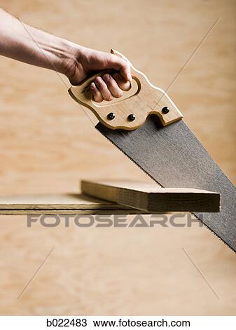 hand sawing a piece of wood View Large Photo Image Stock Image - hand sawing a piece of wood. Fotosearch