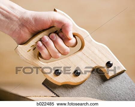hand sawing a piece of wood View Large Photo Image Stock Photography - hand sawing a piece of wood. Fotosearch
