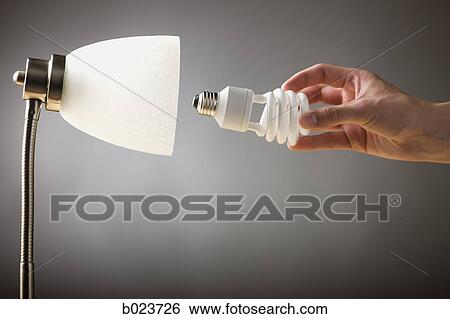 hand screwing a lightbulb into a lamp View Large Photo Image Stock Photograph - hand screwing a lightbulb into a lamp. Fotosearch