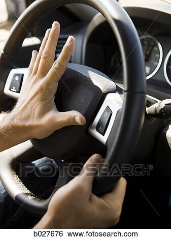 hands on the steering wheel hitting the horn View Large Photo Image Stock Photograph - hands on the steering wheel hitting the horn. Fotosearch