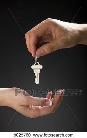 holding out a house key View Large Photo Image Stock Image - holding out a house key. Fotosearch