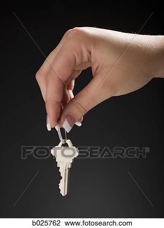 holding out a house key View Large Photo Image Stock Image - holding out a house key. Fotosearch