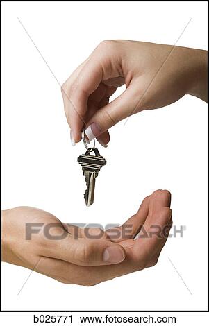 Stock Image - holding out a house key. Fotosearch