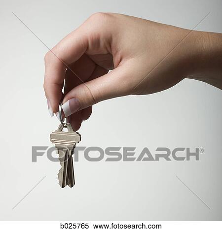 Stock Photography - holding out a house key. Fotosearch
