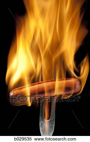 hot dog on a fork completely engulfed in flames View Large Photo Image Stock Photography - hot dog on a fork completely engulfed in flames. Fotosearch