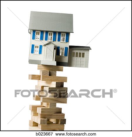 house perched precariously on a tower of blocks View Large Photo Image Stock Photo - house perched precariously on a tower of blocks. Fotosearch