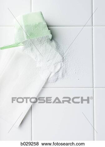 Stock Photo - laundry detergent and dryer sheet on a white tile countertop. Fotosearch