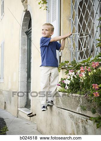 little boy climbing on a window View Large Photo Image Stock Photo - little boy climbing on a window. Fotosearch