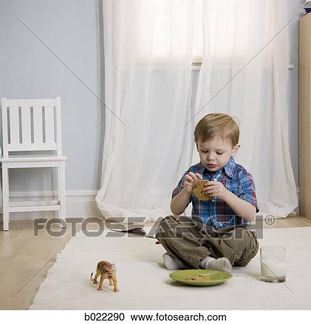 little boy eating a cookie View Large Photo Image Stock Image - little boy eating a cookie. Fotosearch