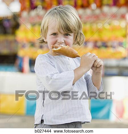 little boy eating a corn View Large Photo Image Picture - little boy eating a corn. Fotosearch