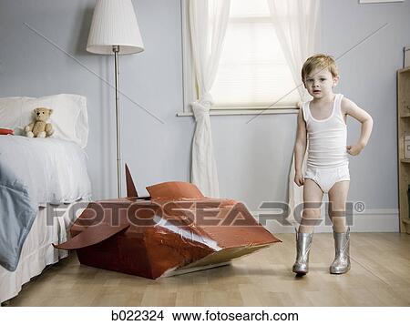 little boy in his room with a red rocketship View Large Photo Image Picture - little boy in his room with a red rocketship. Fotosearch
