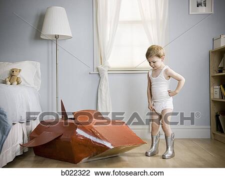 little boy in his room with a red rocketship View Large Photo Image Stock Image - little boy in his room with a red rocketship. Fotosearch
