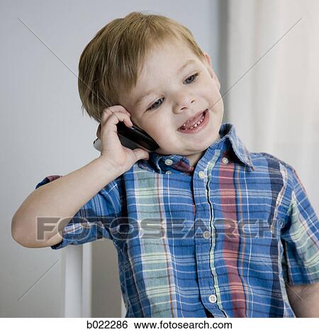 little boy on a cell phone View Large Photo Image Stock Photograph - little boy on a cell phone. Fotosearch