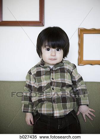 little boy on a couch View Large Photo Image Stock Photography - little boy on a couch. Fotosearch