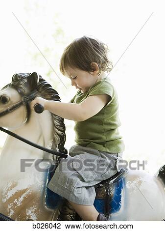 little boy on a rocking horse View Large Photo Image Stock Image - little boy on a rocking horse. Fotosearch
