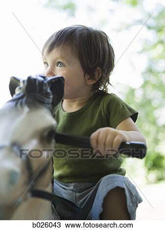 little boy on a rocking horse View Large Photo Image Stock Image - little boy on a rocking horse. Fotosearch