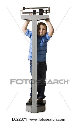Stock Image - little boy on a scale. Fotosearch