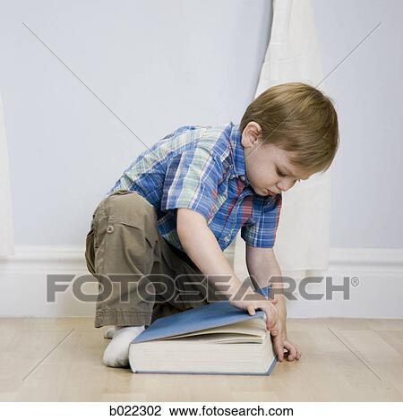 little boy opening a book View Large Photo Image Stock Image - little boy opening a book. Fotosearch