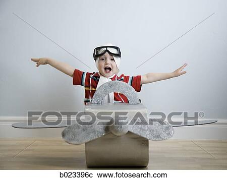 Stock Image - little boy playing dress up. Fotosearch