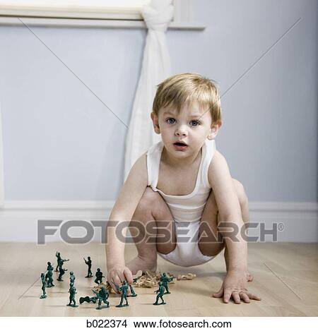 little boy playing with toy soldiers View Large Photo Image Picture - little boy playing with toy soldiers. Fotosearch