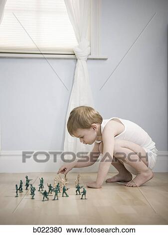 little boy playing with toy soldiers View Large Photo Image Stock Image - little boy playing with toy soldiers. Fotosearch