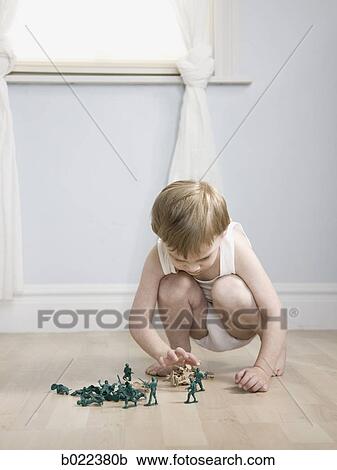 little boy playing with toy soldiers View Large Photo Image Stock Image - little boy playing with toy soldiers. Fotosearch