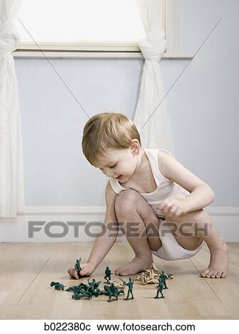 little boy playing with toy soldiers View Large Photo Image Stock Image - little boy playing with toy soldiers. Fotosearch