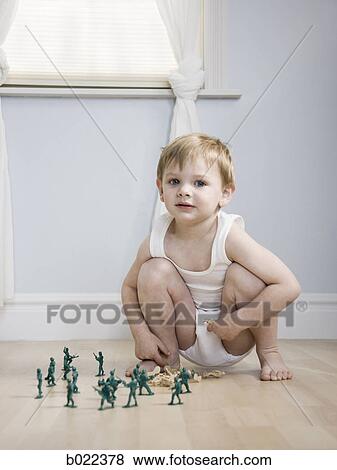 little boy playing with toy soldiers View Large Photo Image Stock Photo - little boy playing with toy soldiers. Fotosearch