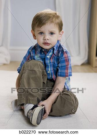 little boy putting on shoes View Large Photo Image Stock Image - little boy putting on shoes. Fotosearch