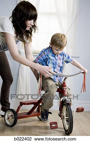 little boy riding a tricycle View Large Photo Image Stock Image - little boy riding a tricycle. Fotosearch