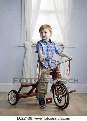 little boy riding a tricycle View Large Photo Image Stock Photograph - little boy riding a tricycle. Fotosearch