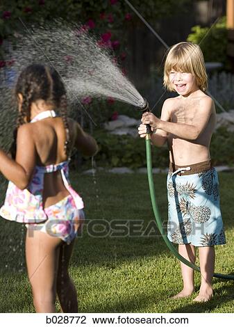 little boy spraying a little girl with the hose View Large Photo Image Stock Image - little boy spraying a little girl with the hose. Fotosearch